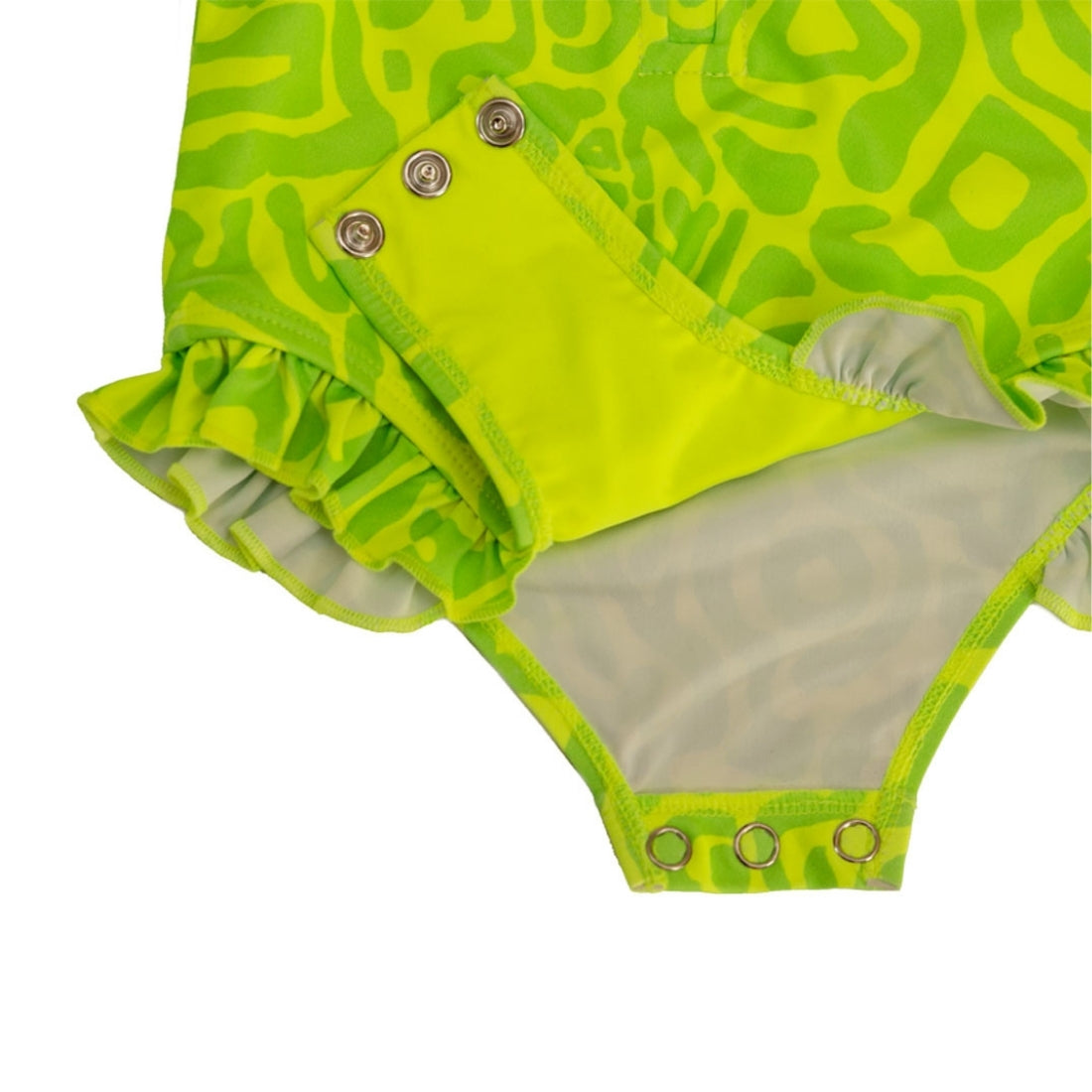Close-up of a Vizzies Swim girls one-piece frill swimsuit in bright lime light pattern, showing the crotch snaps and ruffle details. 