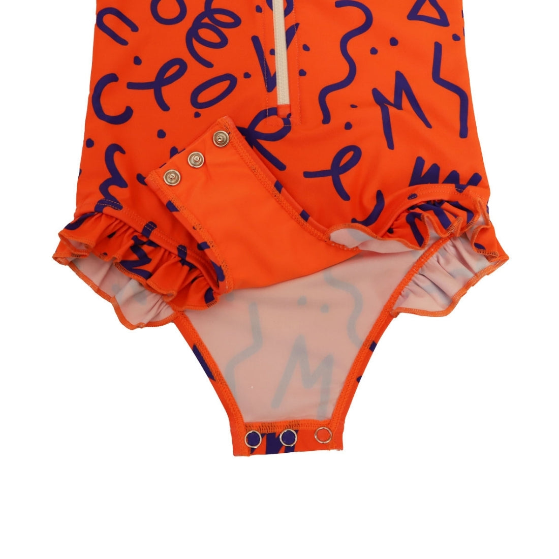 Close-up of a Vizzies Swim girls one-piece frill swimsuit in bright squiggle pop pattern, showing the crotch snaps and ruffle details. 