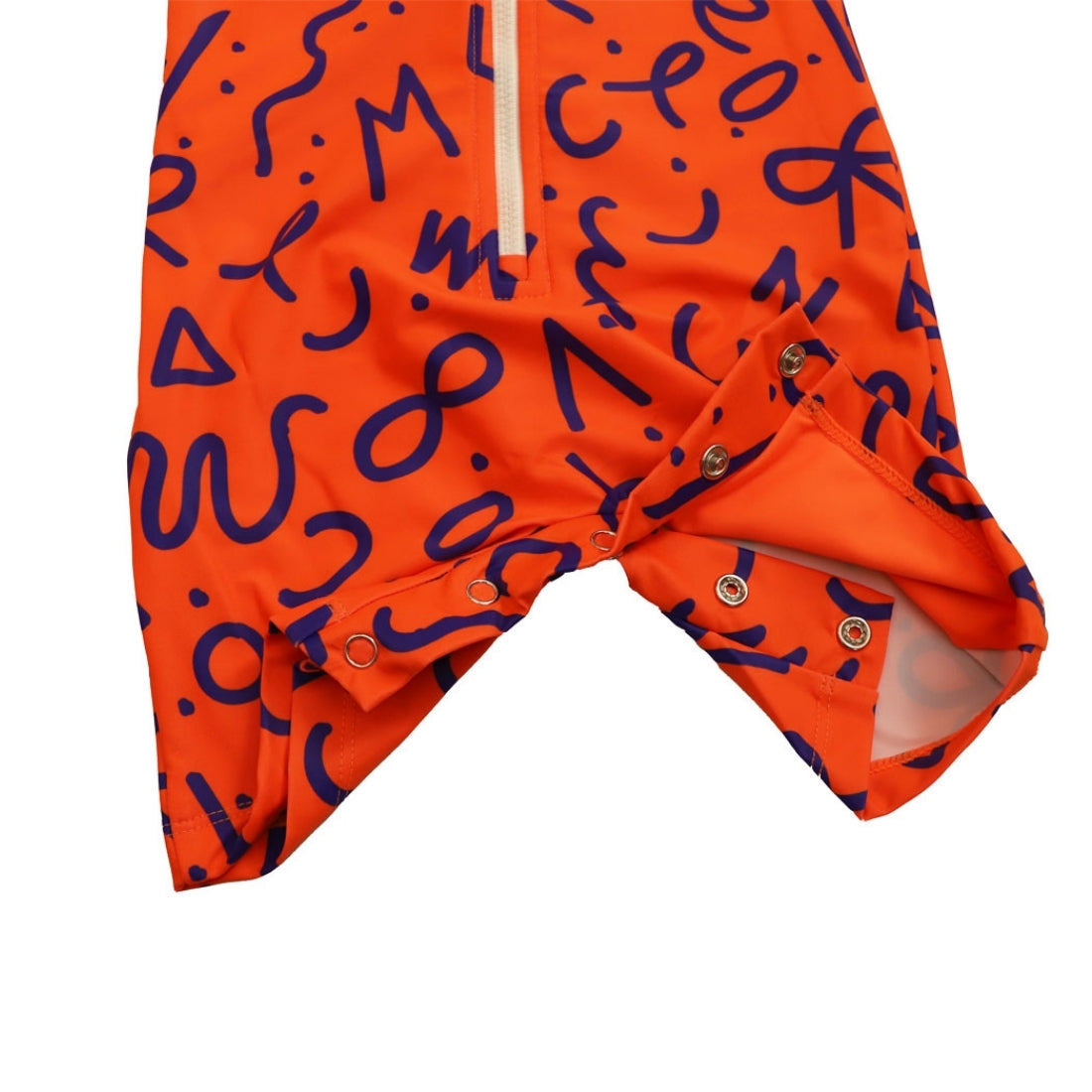 Bright squiggle pop print long-sleeve baby swimsuit from Vizzies Swim with a zipper front and crotch snaps, laid flat on a white background.