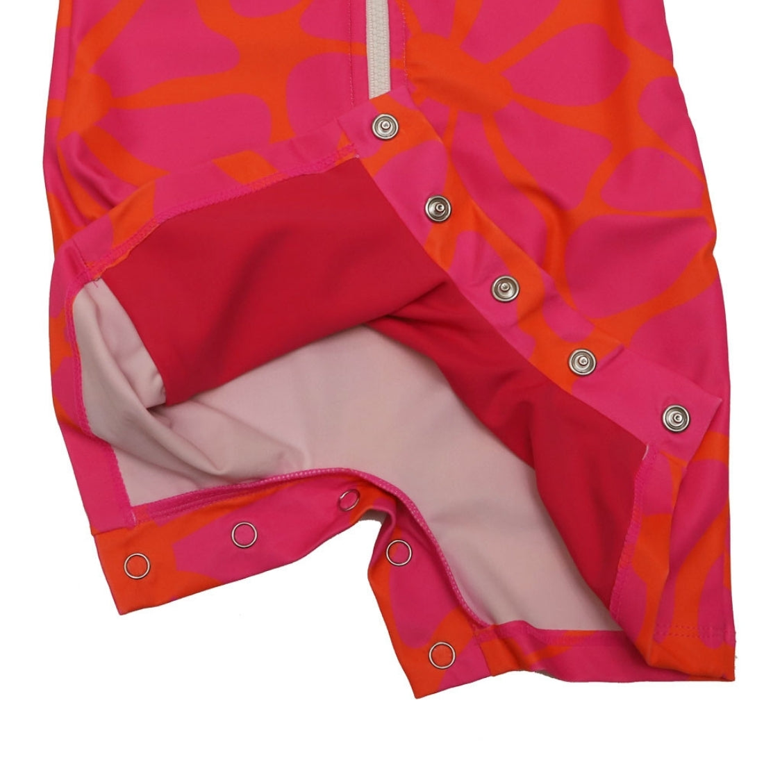Bright tangy blossom print long-sleeve baby swimsuit from Vizzies Swim with a zipper front and crotch snaps, laid flat on a white background.