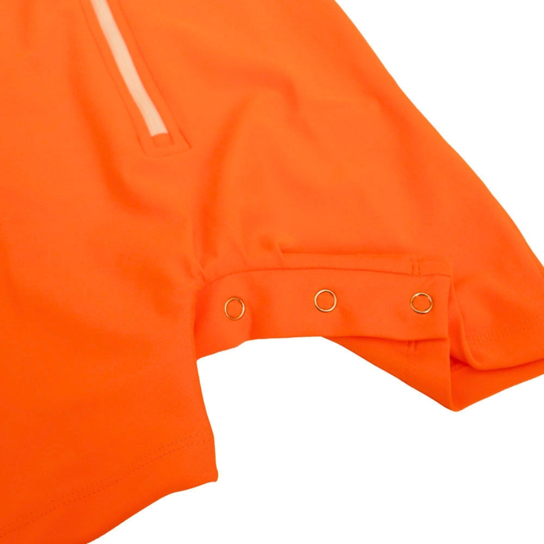 Close-up detail of an orange baby swimsuit, showing the croutch with three metal grommets and a light-colored zipper tab on a white background.