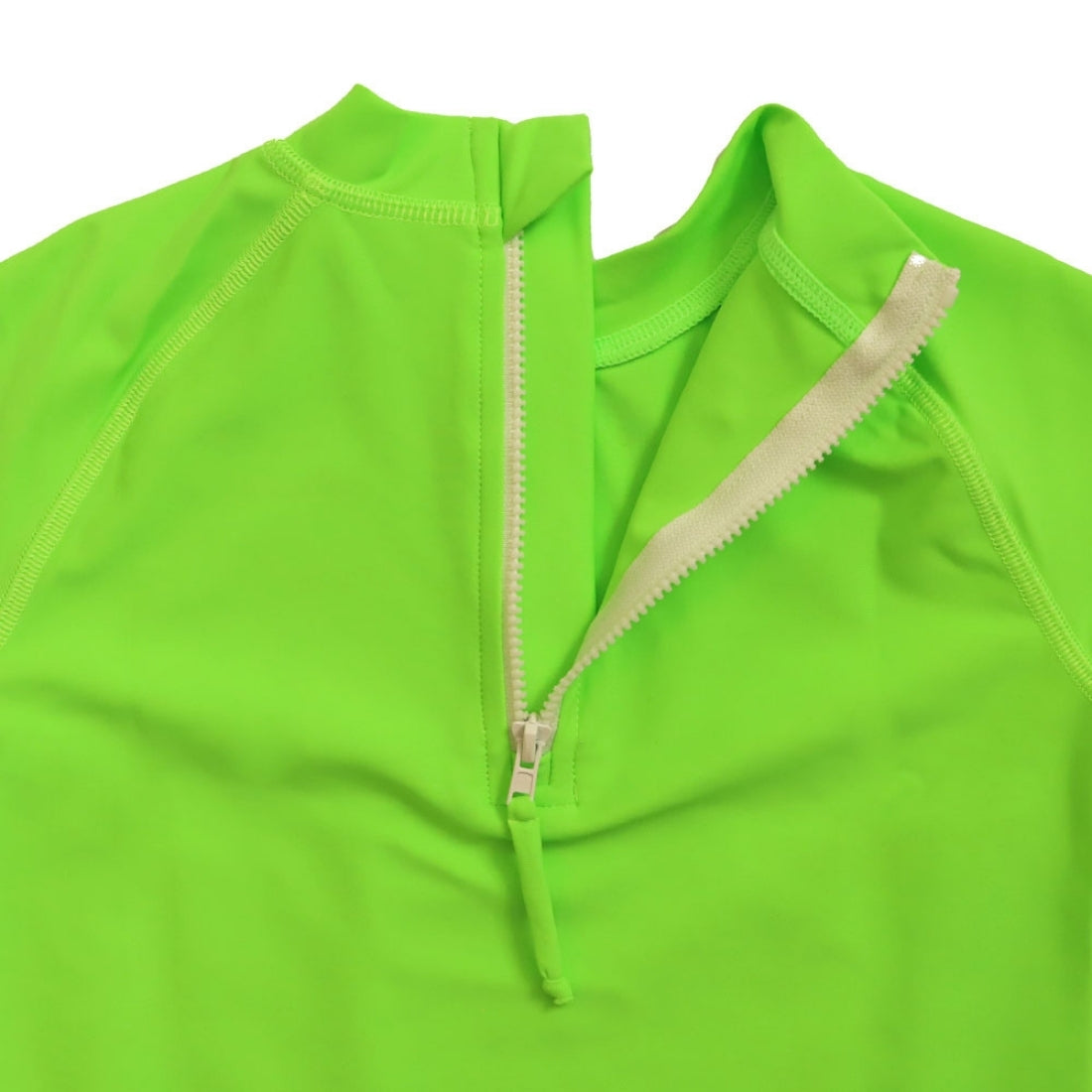 Close-up of a brightgreen kids swim rashie with a white zipper running vertically down the centre.