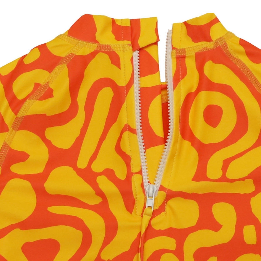 Close-up of a bright sunburst print kids swim rashie with a white zipper running vertically down the centre.
